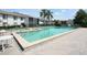 Spacious community pool area with a hot tub, sun loungers, and manicured landscaping at 954 Courtyard Ln # 52, Orlando, FL 32825