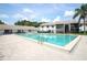 Large community pool with tiled deck and mature palm trees at 954 Courtyard Ln # 52, Orlando, FL 32825