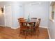Dining area with wood laminate flooring and adjacent entry door to the unit at 954 Courtyard Ln # 52, Orlando, FL 32825
