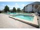 Inviting hot tub and pool area with brick accents and surrounding community buildings at 954 Courtyard Ln # 52, Orlando, FL 32825