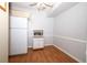 Bright kitchen area featuring a white refrigerator, wooden floors, and a microwave stand at 954 Courtyard Ln # 52, Orlando, FL 32825