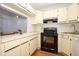Bright kitchen showcasing ample countertop space and modern black appliances at 954 Courtyard Ln # 52, Orlando, FL 32825
