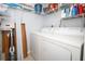 Convenient laundry area with washer, dryer, and shelving at 954 Courtyard Ln # 52, Orlando, FL 32825