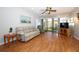 Bright living room with a ceiling fan, sliding glass doors and wood laminate flooring at 954 Courtyard Ln # 52, Orlando, FL 32825