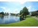 Serene community pond with a fountain and lush greenery at 954 Courtyard Ln # 52, Orlando, FL 32825