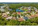 Aerial view of the home in a well-manicured neighborhood with a pond at 9821 Caroline Park Dr, Orlando, FL 32832