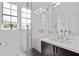 Modern bathroom features a glass shower, large mirror, and dark wood vanity at 9821 Caroline Park Dr, Orlando, FL 32832