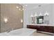 A spacious bathroom with a soaker tub, designer lighting and large double sink vanity at 9821 Caroline Park Dr, Orlando, FL 32832