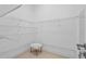 Walk-in closet with adjustable shelving and hanging rods, and a furry chair for seating at 9821 Caroline Park Dr, Orlando, FL 32832