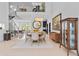 Bright, open dining room features modern lighting, neutral tones and staircase to second floor at 9821 Caroline Park Dr, Orlando, FL 32832