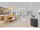 Bright dining room with modern table, white walls, and a large painting at 9821 Caroline Park Dr, Orlando, FL 32832