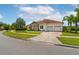 A view of the driveway, landscaping and well-maintained lawn in front of this house at 9821 Caroline Park Dr, Orlando, FL 32832