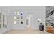 Bright foyer boasts high ceilings and modern art niches near a glass staircase at 9821 Caroline Park Dr, Orlando, FL 32832