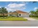 Charming single-story home with a well-manicured lawn, stone accents, and a three-car garage at 9821 Caroline Park Dr, Orlando, FL 32832