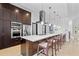 Stylish kitchen features a large island with seating, stainless steel appliances, and dark wood cabinets at 9821 Caroline Park Dr, Orlando, FL 32832