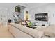 Spacious living room features modern decor, comfortable sofa, chairs, and a sleek entertainment center at 9821 Caroline Park Dr, Orlando, FL 32832