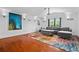 Open living room with hardwood floors, colorful rug, and modern furniture at 9821 Caroline Park Dr, Orlando, FL 32832