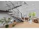 Open-concept living room with modern staircase, comfortable seating and lots of natural light at 9821 Caroline Park Dr, Orlando, FL 32832