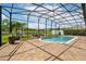 Screened pool with open layout, patio, and view of the lake at 9821 Caroline Park Dr, Orlando, FL 32832