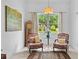 Cozy sitting room offers natural light, comfortable furnishings, and serene garden view at 9821 Caroline Park Dr, Orlando, FL 32832