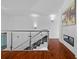 Modern staircase with hardwood floors, glass railing, and modern decor at 9821 Caroline Park Dr, Orlando, FL 32832