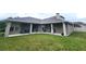 Enjoy the shade of the covered patio, overlooking the grassy backyard at 13157 Paloma Dr, Orlando, FL 32837