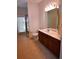 Bathroom featuring tile flooring, modern vanity, light fixtures, toilet, and glass shower door at 13157 Paloma Dr, Orlando, FL 32837
