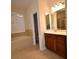 Bright bathroom featuring a large soaking tub, tiled floors, and a vanity with a framed mirror at 13157 Paloma Dr, Orlando, FL 32837