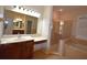 Well-lit bathroom boasts a glass shower, soaking tub, and vanity with drawers and sink at 13157 Paloma Dr, Orlando, FL 32837