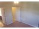 A bright bedroom has neutral walls and carpeted floors with doors leading to adjoining spaces at 13157 Paloma Dr, Orlando, FL 32837