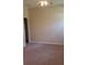 An open bedroom features a neutral colored wall and plush carpeted floors, creating a calming atmosphere at 13157 Paloma Dr, Orlando, FL 32837