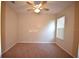 Bedroom features neutral carpet, ceiling fan, and window bringing in natural light at 13157 Paloma Dr, Orlando, FL 32837