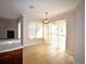 Bright dining area with tile floors, large window and sliding door with light-filtering blinds at 13157 Paloma Dr, Orlando, FL 32837