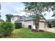 Single-story home showcasing manicured lawns, and a two-car garage at 13157 Paloma Dr, Orlando, FL 32837