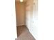 Hallway with neutral colored walls, carpeting, and white bi-fold closet door at 13157 Paloma Dr, Orlando, FL 32837