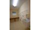 Laundry room with utility sink, shelving, counter, and tile flooring at 13157 Paloma Dr, Orlando, FL 32837