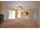Spacious living room features carpet, fireplace, and sliding glass doors to the outside at 13157 Paloma Dr, Orlando, FL 32837