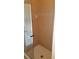 Walk-in shower with tan tile walls and glass enclosure door leading to a door at 13157 Paloma Dr, Orlando, FL 32837