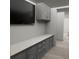 Bonus room featuring custom cabinets, sleek countertops, and a large television for entertainment at Tbd Sw 177Th St, Ocala, FL 34473