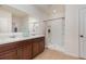 Bathroom featuring tile floors, brown cabinets, shower and double vanity at 1010 Morvan Ln, Kissimmee, FL 34759
