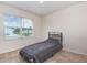 This bedroom features a neutral color palette, large window and comfortable carpet at 1010 Morvan Ln, Kissimmee, FL 34759