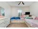 This bedroom features carpet floors, ceiling fan, dresser and two beds at 1010 Morvan Ln, Kissimmee, FL 34759
