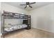 This bedroom features carpet floors, a ceiling fan and a bunk bed at 1010 Morvan Ln, Kissimmee, FL 34759