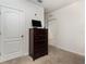 Bedroom featuring carpet floors, door, and a brown dresser at 1010 Morvan Ln, Kissimmee, FL 34759