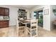 Dining area features a rustic table set and sliding glass door to the screened in patio at 1010 Morvan Ln, Kissimmee, FL 34759