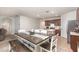 Open-concept dining area with a wooden table and bench seating adjacent to the kitchen at 1010 Morvan Ln, Kissimmee, FL 34759