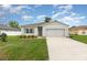 Charming single-story home featuring a well-maintained lawn, two car garage and neutral color palette at 1010 Morvan Ln, Kissimmee, FL 34759