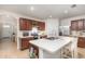 Modern kitchen with a central island, stainless steel appliances, and ample cabinet space at 1010 Morvan Ln, Kissimmee, FL 34759