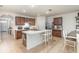 Open concept kitchen with an island, stainless steel appliances, and dark wood cabinets at 1010 Morvan Ln, Kissimmee, FL 34759