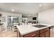 Open concept kitchen with stainless appliances and bar stool seating at the island with the dining area nearby at 1010 Morvan Ln, Kissimmee, FL 34759